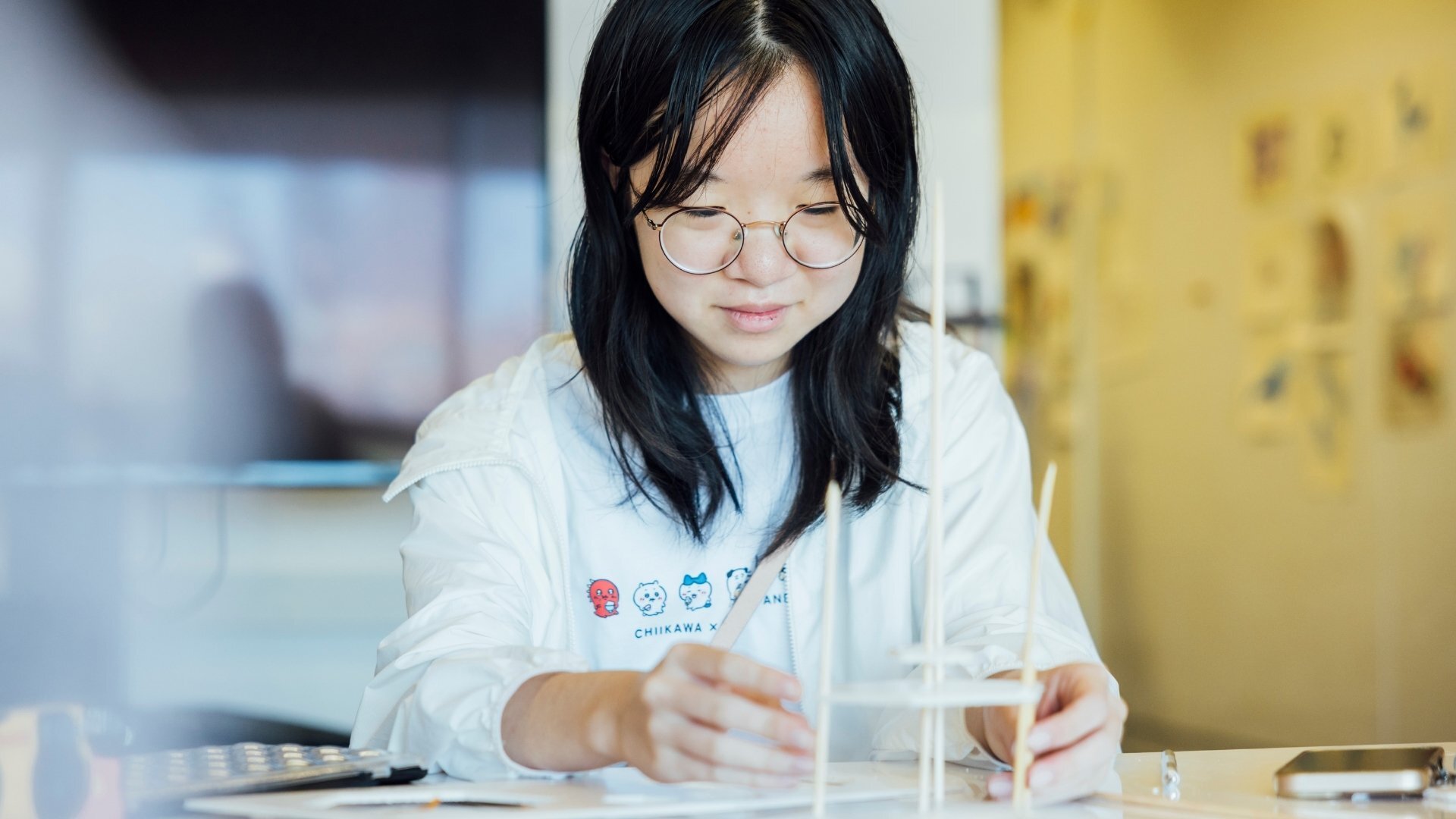 Student creating a scale model.